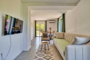 a living room with a couch and a table at Calm apartment in Lepetane in Tivat