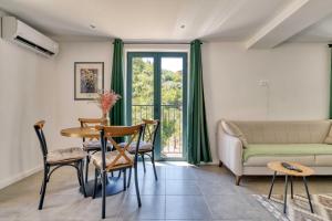 a living room with a couch and a table at Calm apartment in Lepetane in Tivat