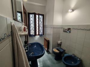 a bathroom with a blue sink and a toilet at Will House 1 in Lanzo Torinese +2 photos