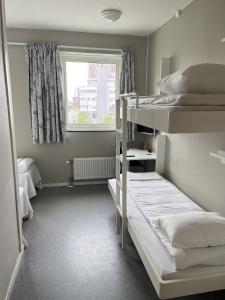 a room with two bunk beds and a window at Bodo Motel Norway in Bodø +12 photos