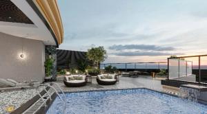 a swimming pool with a view of the ocean at Phoenix Crowne Vinh Hotel in Vinh