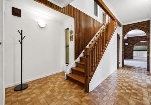 a staircase in a home with white walls and wood floors at 4BR big family house with huge pool in Brisbane +46 photos