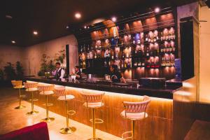 a bar with a row of stools in a restaurant at UNPLAN Kathmandu in Kathmandu