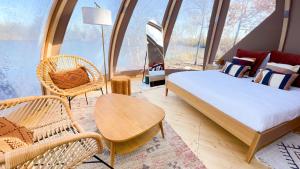 a bedroom with a bed and a table and chairs at Les Etangs de la Bassée in Gravon