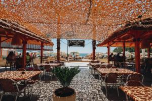 an outdoor restaurant with tables and chairs and umbrellas at Hotel Montenegro in Budva