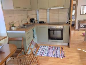 a kitchen with a sink and a stove top oven at Eternal blue in Volos