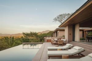 an outdoor patio with a view of the mountains at One&Only Mandarina in Lo de Marcos