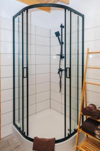 a shower with a glass enclosure in a bathroom at Lisie Bagno - Domki w Lesie Mazury in Miłomłyn +102 photos