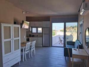 a living room with a kitchen and a dining room at katina 26 in Pitsidia