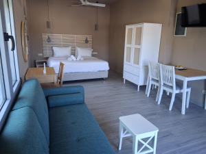 a living room with a couch and a bed and a table at katina 26 in Pitsidia