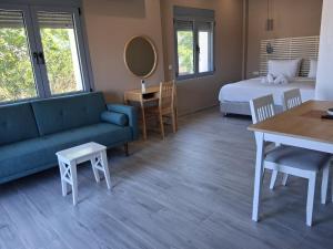 a room with a bed and a couch and a table at katina 26 in Pitsidia +8 photos
