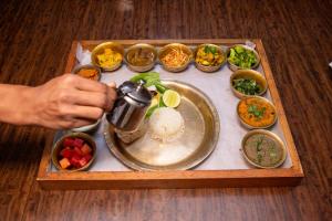 a tray of food with rice and bowls of food at UNPLAN Kathmandu in Kathmandu +7 photos