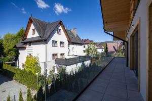 a view from the balcony of a house with a fence at Rysy Boutique Hotel in Zakopane