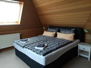 a bedroom with a bed with two towels on it at Baltic Cafe & Concept Store in Maasholm