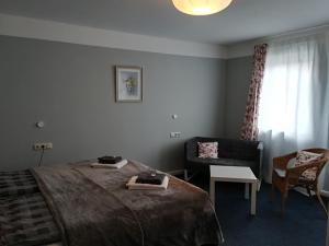 a hotel room with a bed and a chair at Baltic Cafe & Concept Store in Maasholm