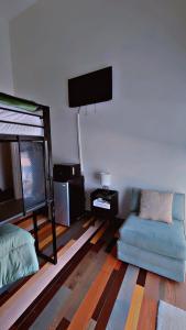 a living room with a couch and a flat screen tv at Ocean Spray Inn in Winthrop