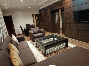 a living room with a couch and a coffee table at Grand Inn & Suites in Ijebu Ode