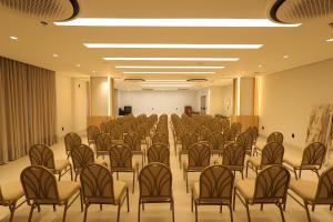 an empty conference room with chairs and a podium at Grand Maison Hotel in Porto Velho +116 photos