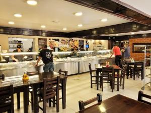 a restaurant with people preparing food in the kitchen at Pensiune Iguana in Tulcea +44 photos