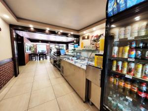 a fast food restaurant aisle with a food counter and drinks at Pensiune Iguana in Tulcea