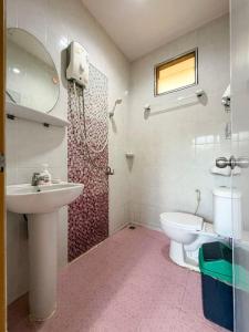 a bathroom with a toilet and a sink and a shower at Neziha's Homes in Thong Sala