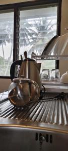 a couple of pots and pans sitting on top of a stove at Neziha's Homes in Thong Sala