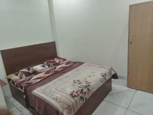 a bed in a room with a bedspread on it at Hotel Tokyo in Bathinda