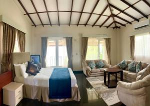 a living room with a bed and a couch at Nilakma Lagoon in Negombo