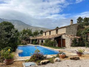 a house with a swimming pool in front of it at Casa de la Suerte in Benissa