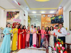 a group of people posing for a picture at a wedding at Tân Hiệp 2 Hotel in Bùi Tiếng