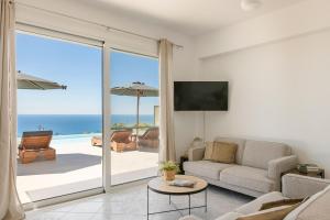 a living room with a view of the ocean at Ionian Dreaming in Lourdata