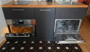 a kitchen with a dishwasher next to a sink at Antony City Center Studio AC in Antony