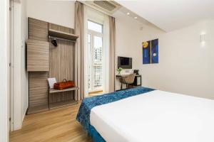 a hotel room with a bed and a window at Municipio Luxury Suite in Naples