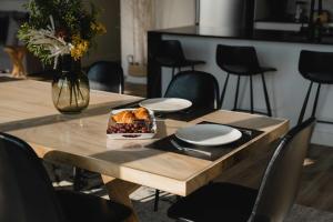 a table with a plate of food on top of it at 211 - Bright Condo - Pool and Cozy Atmosphere in Baie-Saint-Paul