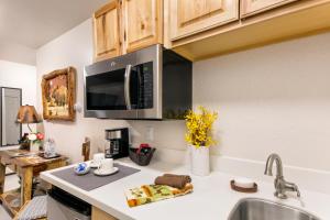 a kitchen with a sink and a microwave at Mat-Su Resort in Wasilla