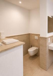 a bathroom with a toilet and a sink at Gemütliche Ferienwohnung in Burgberg in Giengen an der Brenz