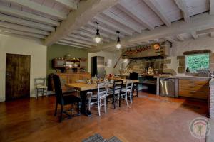 a kitchen and dining room with a table and chairs at La bremande in Saint-Georges-de-Reintembault