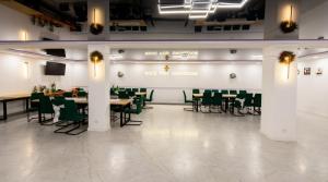 a dining room with tables and green chairs at Noce pod Gwiazdami in Sidzina +9 photos