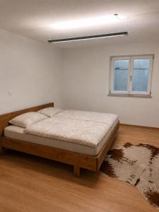 a bedroom with a bed in a white room at Gemütliche Ferienwohnung in Burgberg in Giengen an der Brenz