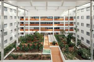 an apartment building with a garden in the middle at Courtyard by Marriott Prague Airport in Prague +66 photos
