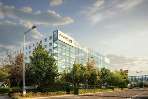 a building with a sign on the side of it at Courtyard by Marriott Prague Airport in Prague
