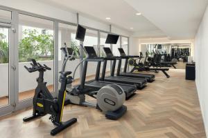 a gym with treadmills and elliptical machines at Courtyard by Marriott Prague Airport in Prague