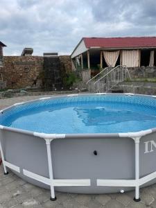 a large swimming pool in front of a house at Vibe Hotel Vanadzor in Vanadzor