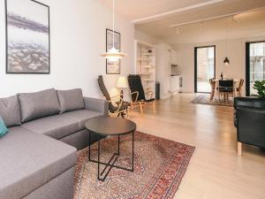 a living room with a couch and a table at Vedersø Holiday Center in Ulfborg