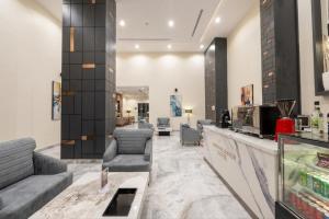 a lobby of a hotel with couches and chairs at Garden Melenium - Jeddah in Jeddah