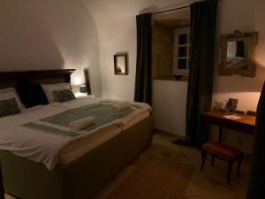 a bedroom with a large bed and a desk at Château la Gineste - Castle and Vineyard in Duravel