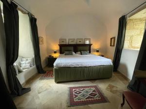 a bedroom with a large bed in a room at Château la Gineste - Castle and Vineyard in Duravel
