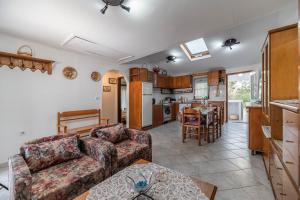 a living room with a couch and a kitchen at Villa Hara Kiotari in Gennadi