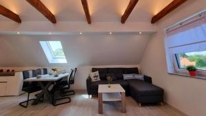 a living room with a couch and a table at Ferienwohnung Brunnenaue in Sagard