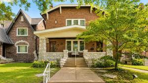 a brick house with a tree in front of it at Historic 2BR with Deck Games & Garage in Saint Louis